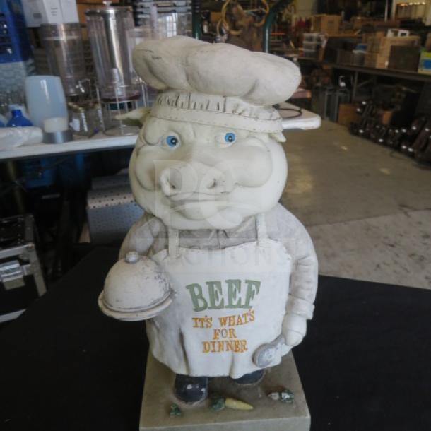 Pig decor statue with chef hat and apron reading "BEEF IT'S WHAT'S FOR DINNER," holding a platter. Good condition.
