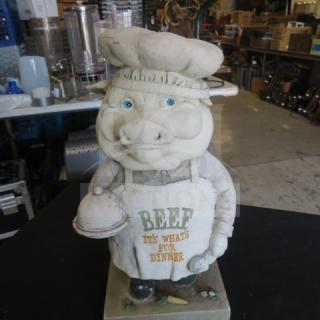 Pig decor statue with chef hat and apron reading "BEEF IT'S WHAT'S FOR DINNER," holding a platter. Good condition.