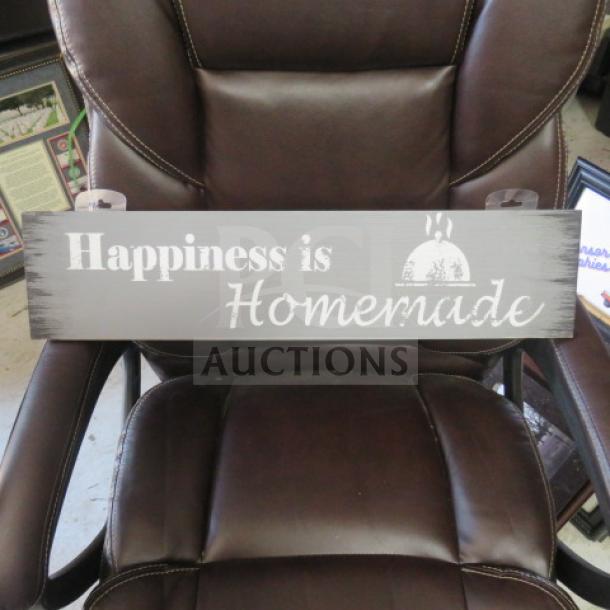 Decorative sign reading "Happiness is Homemade" in white on gray wood, rectangular shape, good condition.