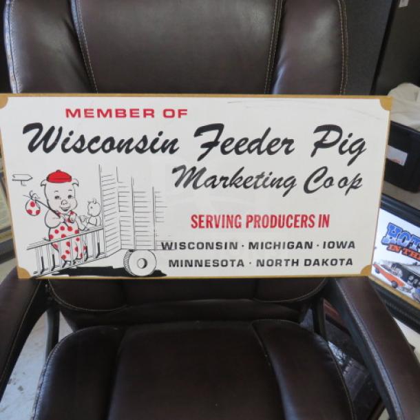 Decorative sign for Wisconsin Feeder Pig Marketing Coop, features cartoon imagery, lists U.S. states; in good condition.