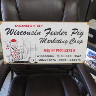 Decorative sign for Wisconsin Feeder Pig Marketing Coop, features cartoon imagery, lists U.S. states; in good condition.