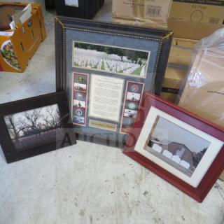 Three assorted framed pictures, including landscapes and memorial imagery, in varied frame styles and colors, in good condition.