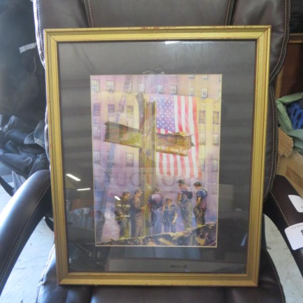 Framed picture, 18x22 inches, depicting firefighters at a memorial cross with U.S. flag backdrop. Gold frame, glass-covered.