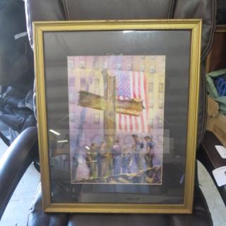 Framed picture, 18x22 inches, depicting firefighters at a memorial cross with U.S. flag backdrop. Gold frame, glass-covered.