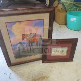 Framed western-themed prints in dark wood frames, one large with a cowboy and horse, one smaller with riders, good condition.
