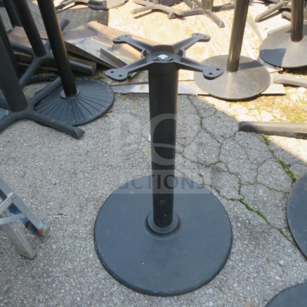 Metal table base with round, heavy-duty support. Black finish, suitable for various tabletop styles. Good condition.