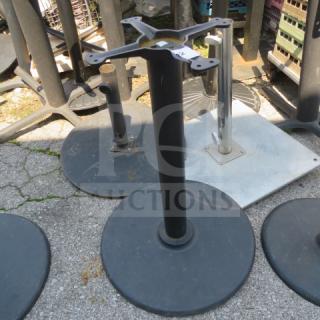 Black metal table base with round, heavy-duty support. Used condition with visible wear. Ideal for replacement or DIY projects.