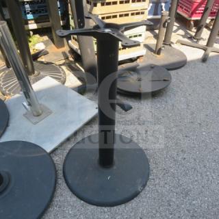 Round black metal table base with mounting bracket, used condition, suitable for various tabletop styles.