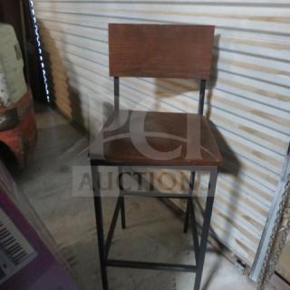 Black metal bar-height chair with wooden seat and back, in good condition, sturdy design.