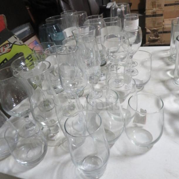 Assorted stem glasses in varying shapes and sizes on a table, in good condition, suitable for dining and entertaining.