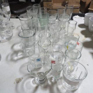Assorted glassware lot including various sizes and shapes, clear glass, mixed condition; ideal for collectors or resellers.