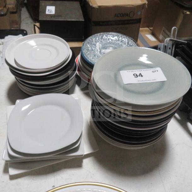Assorted salad plates in multiple styles and colors stacked in a lot, includes circular and square designs, labeled as "One Mega Lot."