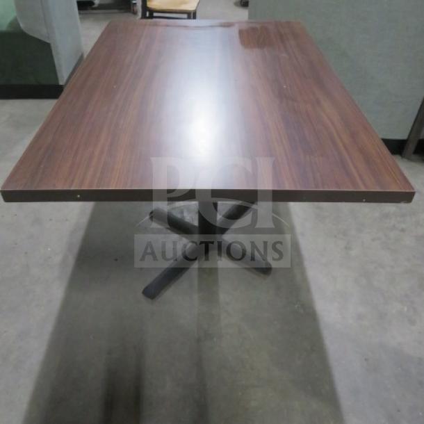 Brown laminate table top with pedestal base, 45x30x30 inches. Excellent condition, sturdy, and ideal for dining or workspace.
