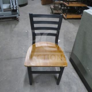 Black metal chair with a wooden seat, 2XBID model. Features ladder-back design, good condition, sturdy construction.