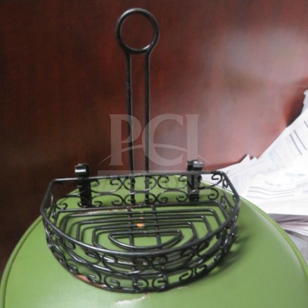 Black metal tabletop condiment holder with intricate scroll design, two clips, and loop handle. Model 10XBID. Good condition.