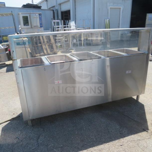 Advance Tabco 5-well electric steam table, model HF-5E-240-BS, with SS serve shelf, sneeze guard, storage, on casters.