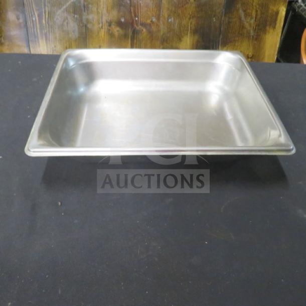 Stainless steel half-size 4-inch deep hotel pan in good condition. Ideal for catering or food service use.