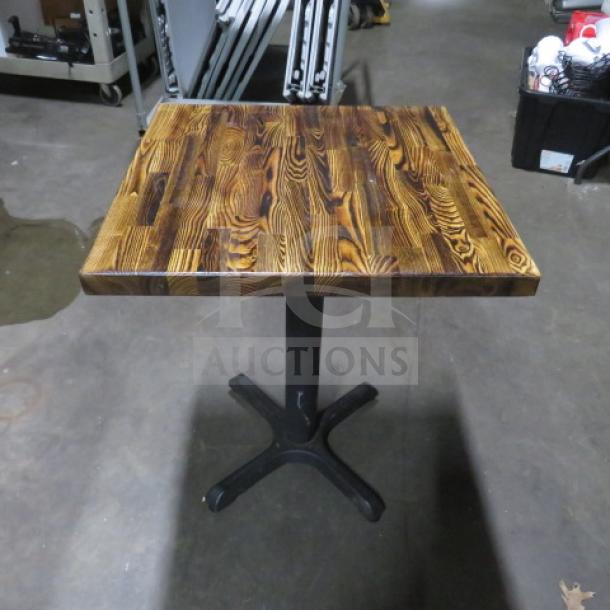 Butcher block table top on pedestal base, 24x24x30 inches. Features rich wood grain and sturdy metal base. Excellent condition.