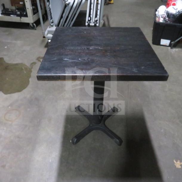 Butcher block table on a pedestal base, 24x24x30 inches, dark wood top, metal base, in good condition.