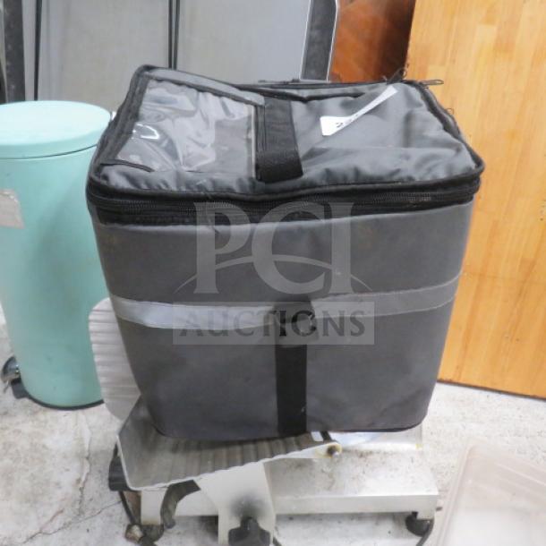 Winco insulated food carry bag in gray, zipper closure, good condition. Features carrying handles and reflective strip.