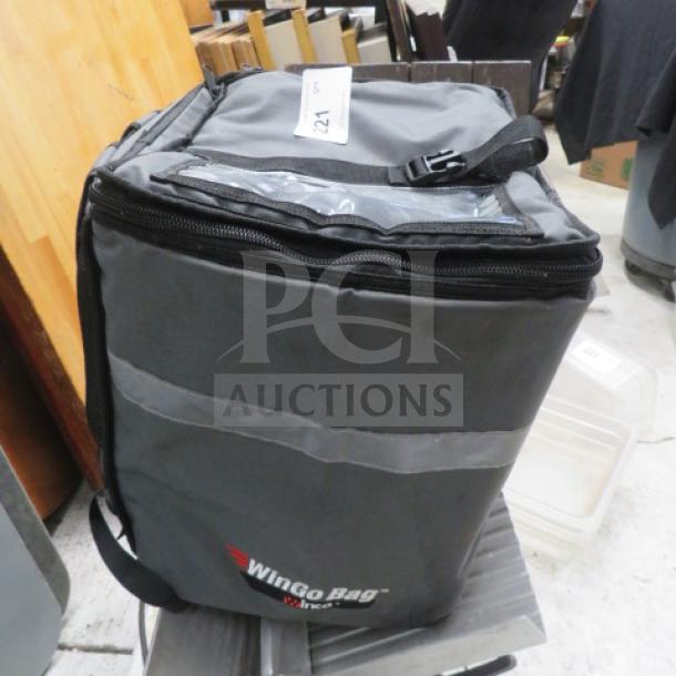 Winco insulated food carry bag, gray with black accents, zipper closure, visible brand logo, tag marked "124".