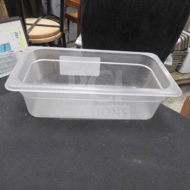 Clear one 1/3 size, 4-inch deep food storage container, in used condition. Transparent material with visible label space.