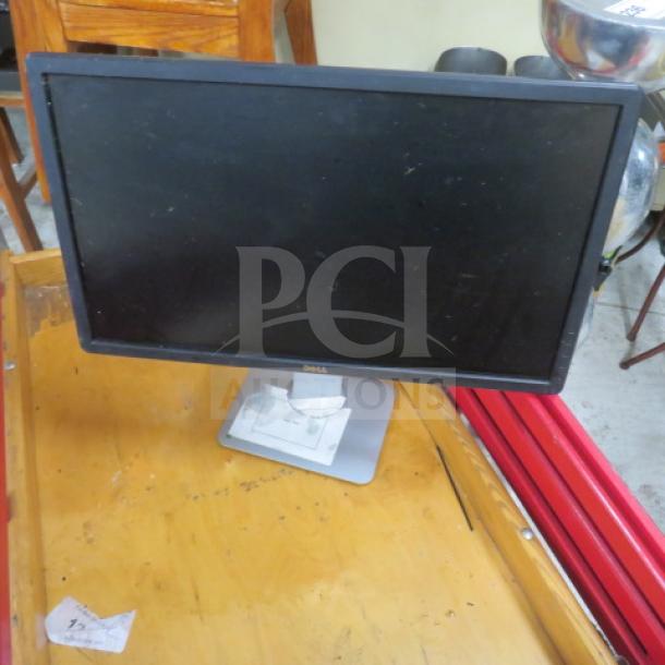 Dell flat panel monitor on a stand, black frame, visible Dell logo, good condition, no visible screen damage.