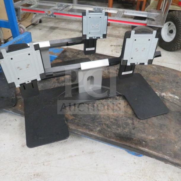 Dell Dual Monitor Holder 2XBID, supports two monitors, black and silver, adjustable arms, sturdy base, used condition.