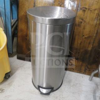 Stainless steel step trash can, cylindrical design, foot pedal, minor scuff marks, good condition.