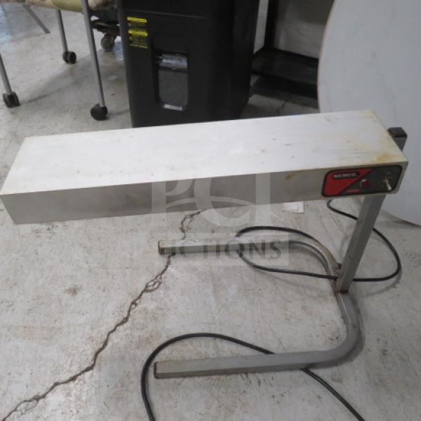 Nemco 6152-24 Food Warmer, 120V, 500W, measures 25"x14"x17", silver, visible wear; logo and controls on front.