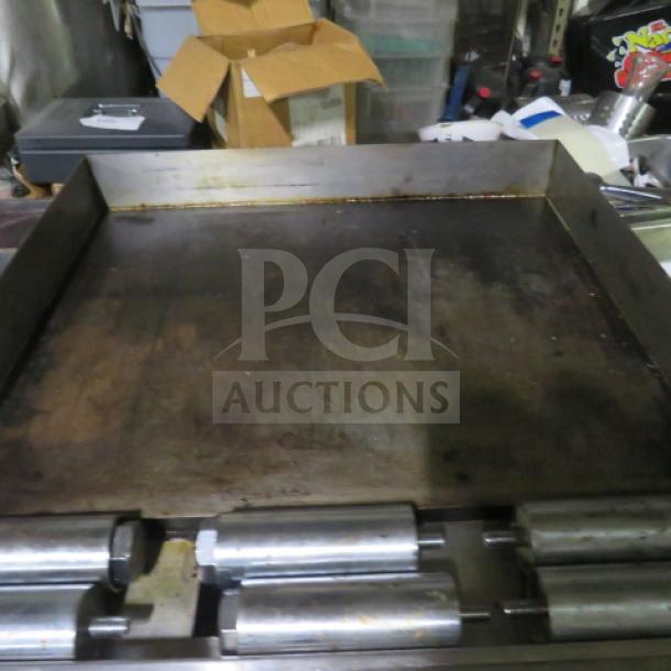 Sierra SR6B24G60 natural gas range. Features 6 burners, griddle, 2 racks. Dimensions: 60"x32"x40". Used condition.