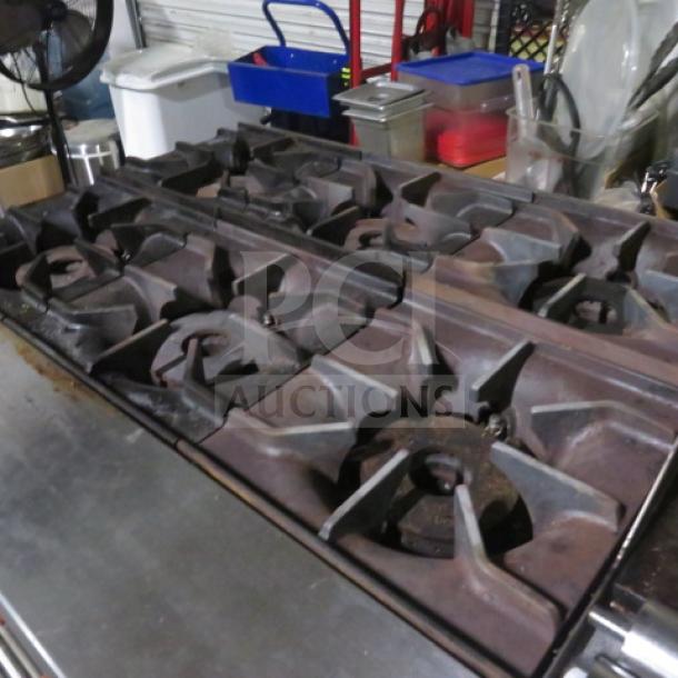 Sierra SR6B24G60 natural gas range with 6 burners, griddle, and 2 racks; dimensions 60x32x40; used condition.