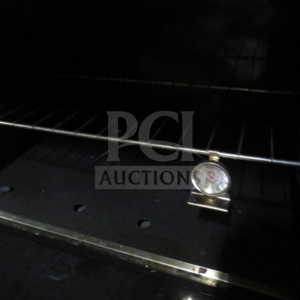 Sierra SR6B24G60 natural gas range, interior view with rack and thermometer. Features 6 burners, griddle, two racks.