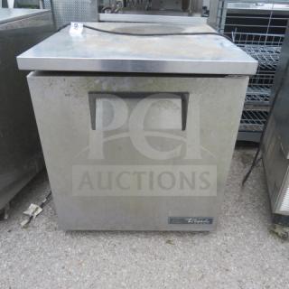 True TUC27F-LP-HC one-door worktop freezer on casters, measures 27.5x30x32 inches, 115V, includes one rack, visible wear.