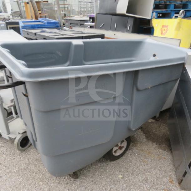 Rubbermaid hand truck with damage at the bottom, grey color, two rear wheels, visible Rubbermaid logo.
