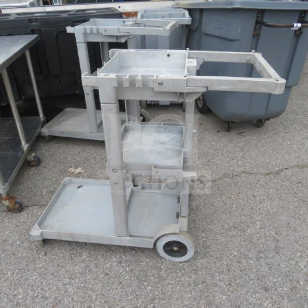Rubbermaid janitor cart on casters, model 6152-02. Features multiple shelves and storage compartments. Used condition.