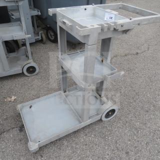 Rubbermaid janitor cart on casters, model 6152-02, gray, missing one wheel, used condition, auction tag visible.