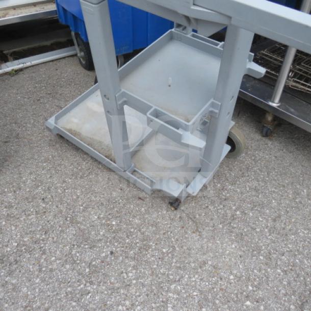 Rubbermaid janitor cart 6152-02, missing one wheel, gray, on casters, visible wear, sturdy metal construction.