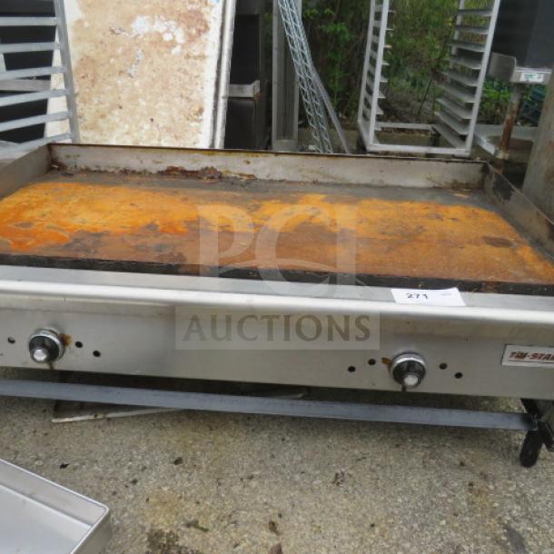 Tri Star Natural Gas Griddle, 48x35x17. Visible rust on surface, includes control knobs. Model tag reads "Tri Star." Used condition.