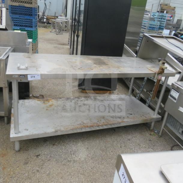 Stainless steel table with under shelf and 10lb can opener, 72x30x34 inches. Shows signs of wear, ideal for industrial use.