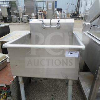 Stainless steel free-standing sink with faucet, 27x28x40 inches, good condition, visible tag with number 276.