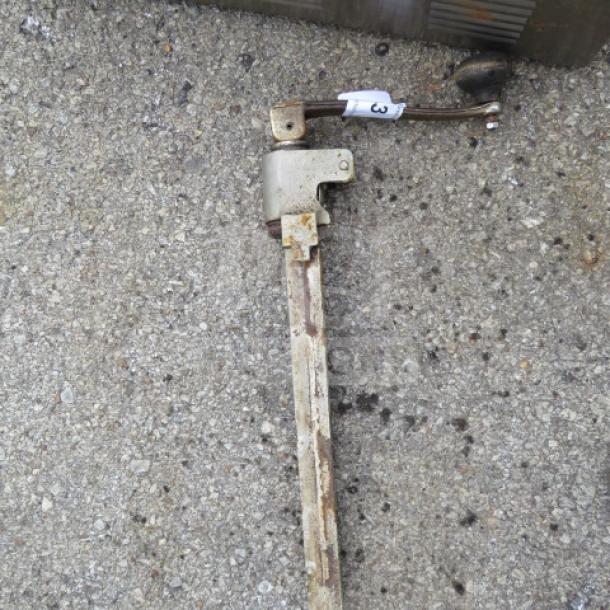 Heavy-duty 10lb can opener with long metal handle and visible rust, numbered tag attached, used condition.