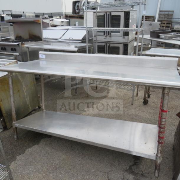 Stainless steel table with backsplash, under shelf, 72x30x38, in used condition, ideal for commercial kitchens.