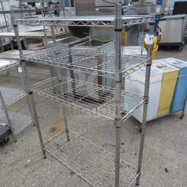 Metro metal shelf unit with four shelves, 36x14x54 inches. Slightly worn condition, ideal for storage or organization.