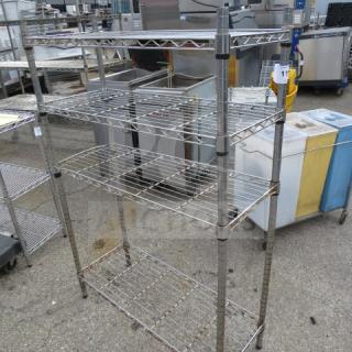 Metro metal shelf unit with four shelves, 36x14x54 inches. Slightly worn condition, ideal for storage or organization.