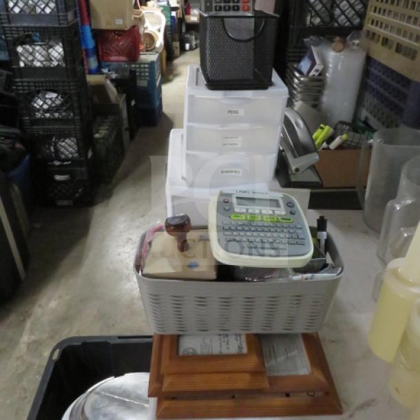 Lot of assorted office supplies including label maker, stapler, storage bins; good condition, ideal for home or office use.