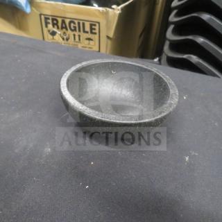 Black molcajete bowl made of stone, circular shape, three small feet, excellent condition, suitable for grinding spices.