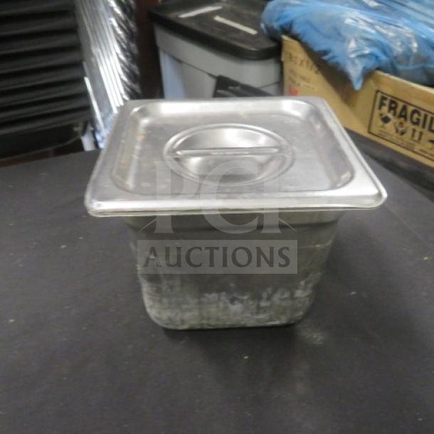 1/6 size hotel pan, 6-inch deep, with lid. Stainless steel, used condition with minor wear. Ideal for food service.