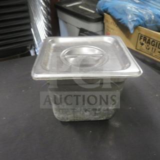 1/6 size hotel pan, 6-inch deep, with lid. Stainless steel, used condition with minor wear. Ideal for food service.
