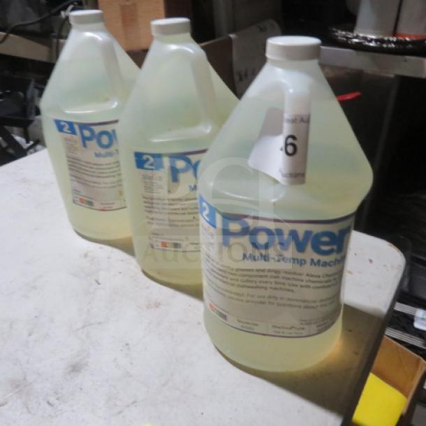Three gallons of Power Up Multi-Temp Machine Cleaner, with labels indicating usage instructions and safety precautions.